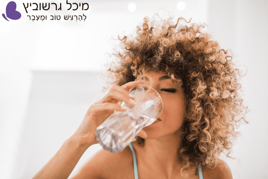 אישה בגיל המעבר מחייכת ומתחילה את היום עם הרגל בריא